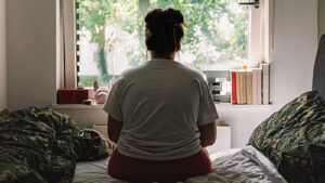 Person Alone Looking Out Window